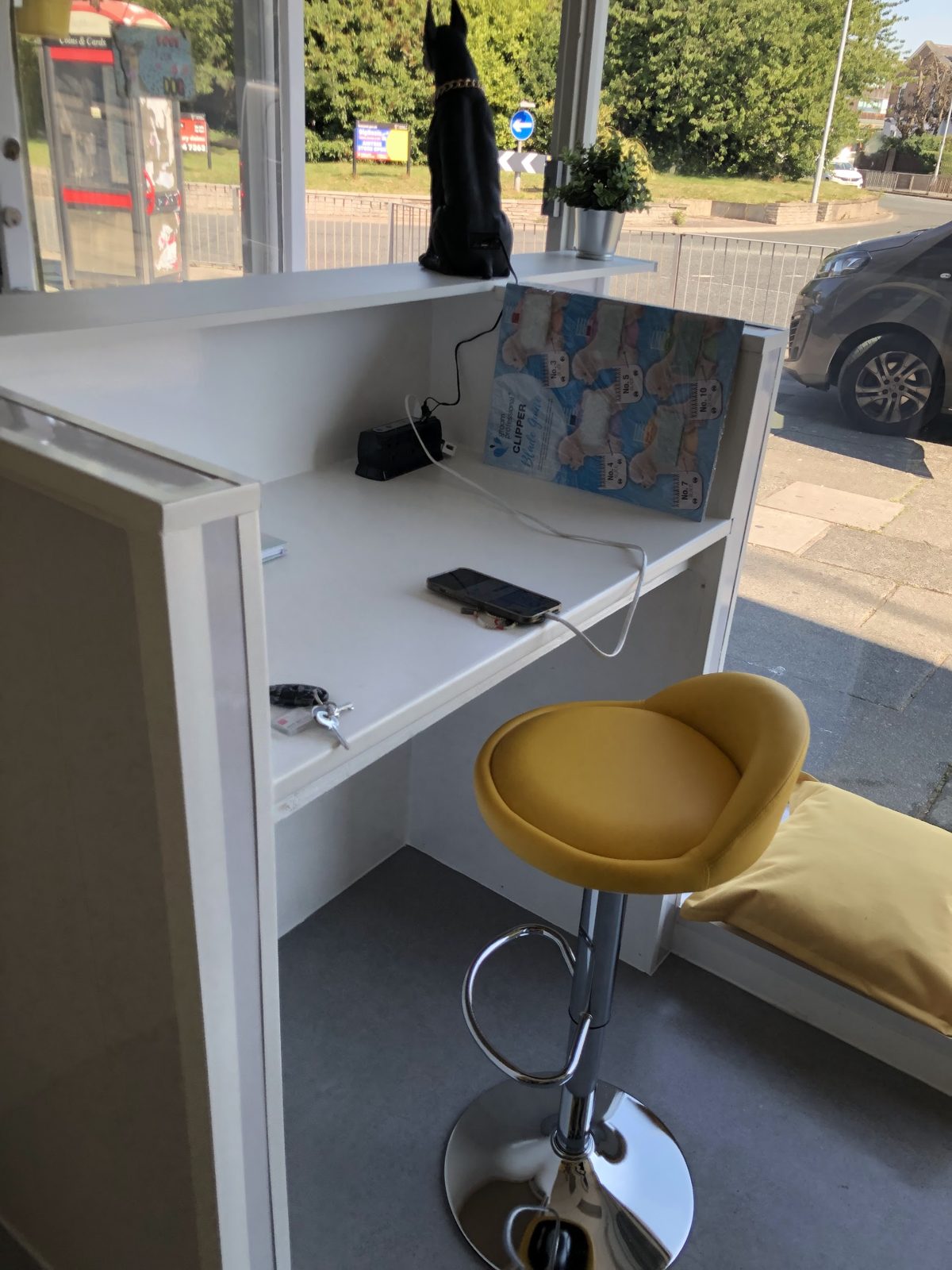The front desk at Bertie's House with a yellow stool, looking out onto West Derby Road